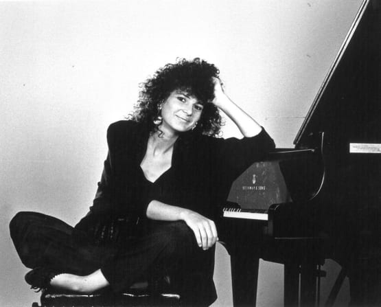 Joanna MacGregor leaning on piano